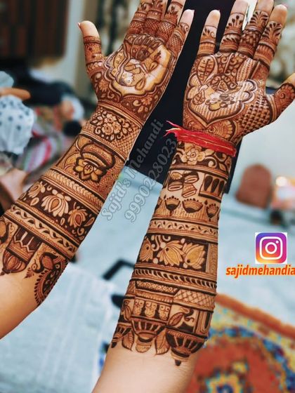 A full view of the design from the previous image, showing both hands. The artwork includes the ring ceremony, doli, and other auspicious symbols like the kalash and lotus flowers, all tied together with intricate patterns.