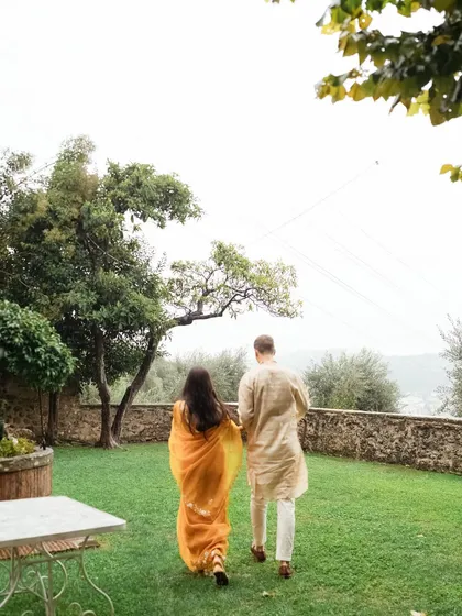 A quiet, candid moment of the couple walking hand-in-hand through the lush gardens of their Italian wedding venue. It's these simple, peaceful moments that I love to capture.