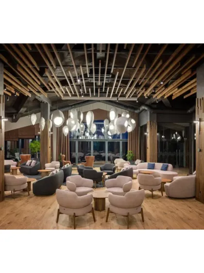 A wide shot of the cafe lounge, highlighting the spacious layout and the striking ceiling design with wooden slats.