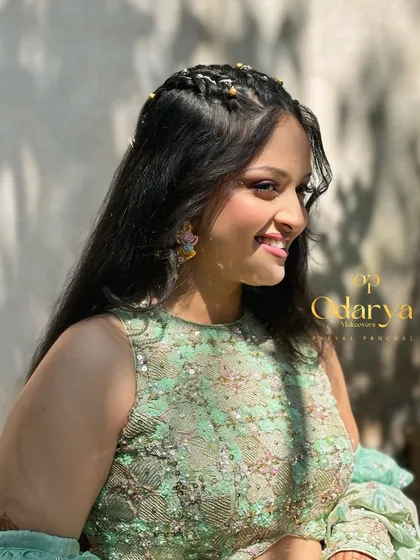 This profile shot shows the beautiful half-up braided hairstyle, which is both stylish and practical for a daytime event.