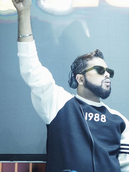 I make vibes, not noise. An action shot of me with my arm raised, feeling the music during a set.