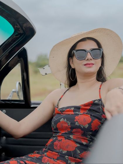 A chic solo portrait of the bride in the vintage car, looking cool and confident.