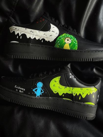 A pair of black Nike Air Force 1s with a custom Rick and Morty design, featuring Mr. Meeseeks and Morty.