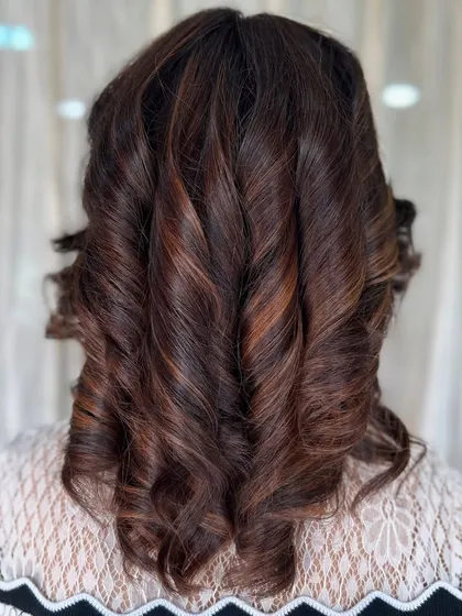 A perfect example of classic, voluminous curls on medium-length hair. This style adds glamour and sophistication and is perfect for any special occasion.