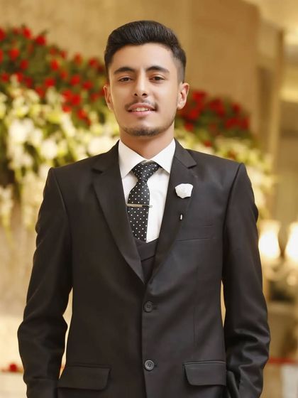 A classic reception look. This groom in a black suit looks elegant and ready to celebrate his new beginning.