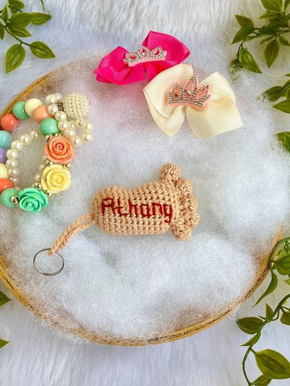 The 'Athang' keychain displayed in a gift setting.