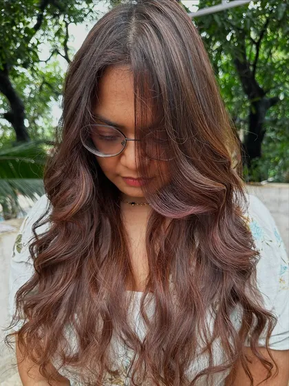 Getting ready for 'Ghar ki shaadi' (a home wedding). This client wanted a glamorous but natural look, so I gave her a rich color melt with soft waves, perfect for the occasion.