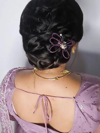 Another angle of the elegant reception updo, showing the intricate details of the bun and the beautiful hair accessory.