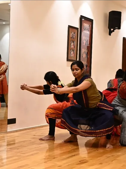 The mirrored wall of the studio reflects the dancers' movements during a rehearsal for 'Songs of the Millstone'. This image shows the precision and synchronicity required for a group choreography.