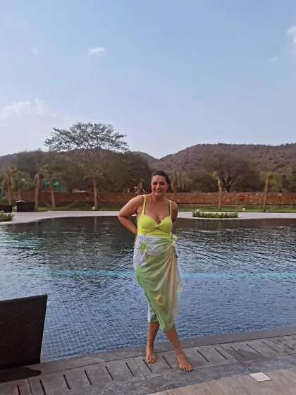 By the pool at Ananta Spa & Resort, Ajabgarh. A bright yellow swimsuit with a light sarong is a classic and stylish choice for a day of swimming and sunbathing.
