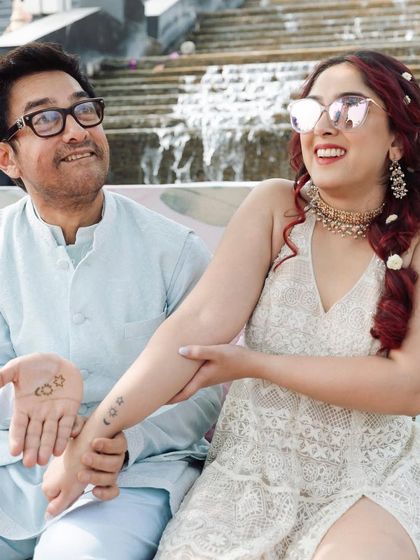 The joy on their faces says it all. This candid shot captures the bride and her father sharing a moment of pure happiness during the wedding festivities.