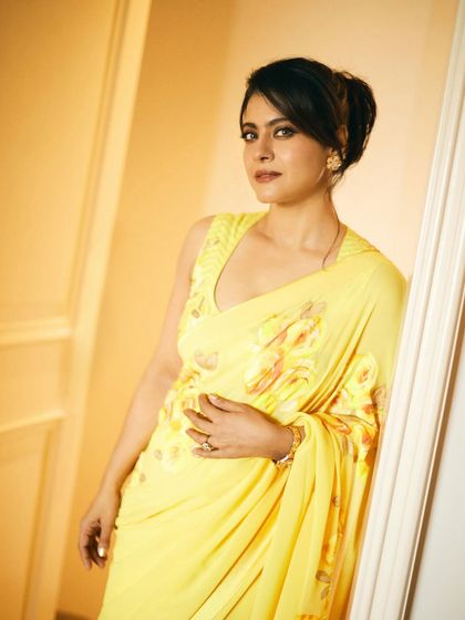 Kajol in a vibrant yellow floral saree, a perfect look for movie promotions that is both cheerful and elegant.