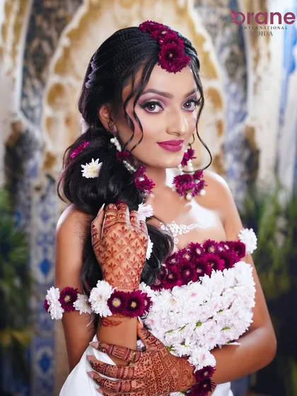 A beautiful shot that highlights the intricate henna work against the fresh flower jewelry.