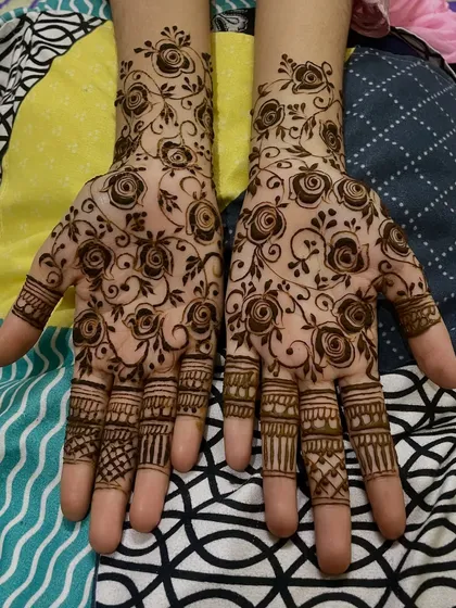 A gorgeous full-hand design with rose motifs and detailed finger work, perfect for Eid or a wedding.