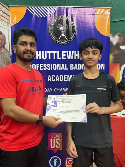 A coach congratulates a student during the certificate distribution at our 2024 in-house tournament, fostering a sense of achievement.
