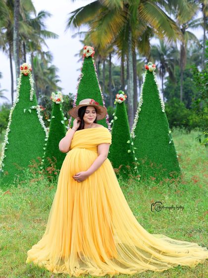A lovely solo portrait in a yellow gown, set against our unique cone-shaped green props.