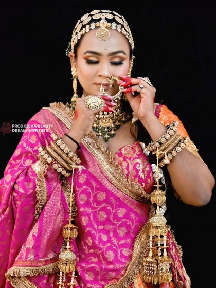 A closer look at the traditional bridal braid, showing how it's accessorized with a passa and maang tikka. The details in the hair and jewelry come together for a truly royal look.