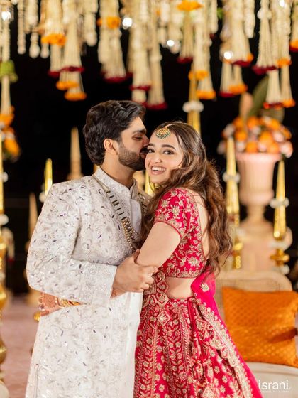 A sweet moment between the bride and groom. The bride's makeup is soft and romantic, perfect for these cherished memories.