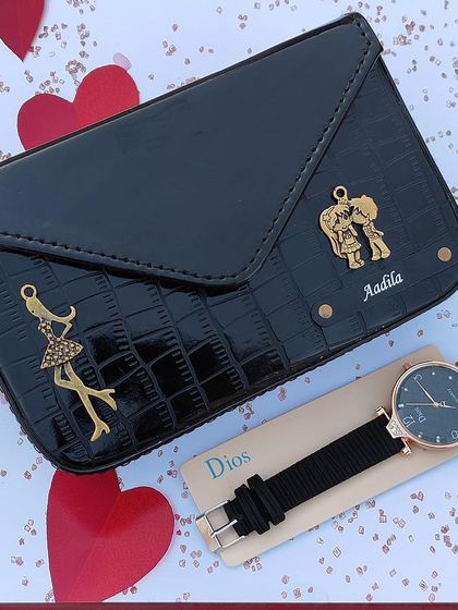 The same sling bag and watch combo, shown here in classic black with cute charms.