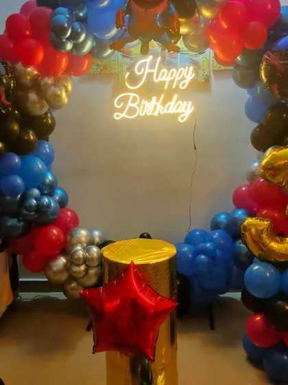 A duplicate of image 123, showing a Spiderman-themed circular balloon arch with a neon sign.