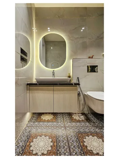 For this bathroom, I used beautiful patterned floor tiles to add a touch of classic charm. The design is balanced with a modern floating vanity, an oval backlit mirror, and clean white marble walls.