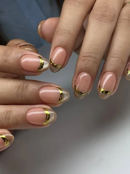 An elegant and modern design featuring a nude base with gold chrome accents that wrap around the nail, creating a sophisticated and luxurious look.
