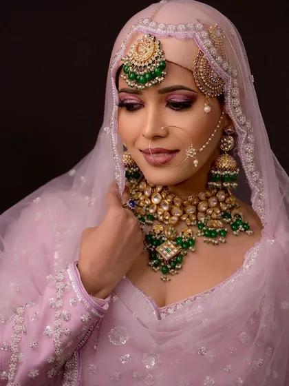 A close-up on the eye makeup, showing a soft pink and brown blend with a sharp wing.