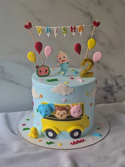 The wheels on the bus go round and round! This Cocomelon cake is perfect for a second birthday, featuring JJ, the iconic yellow school bus, and animal friends.