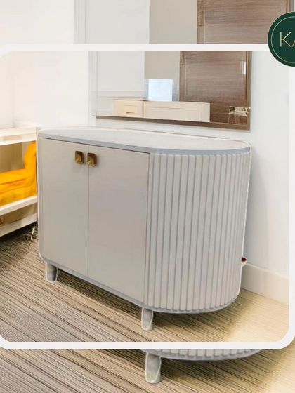 This small, curved cabinet with ribbed side detailing is a perfect example of our ability to create unique, compact storage solutions that don't compromise on style.