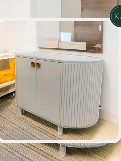 This small, curved cabinet with ribbed side detailing is a perfect example of our ability to create unique, compact storage solutions that don't compromise on style.