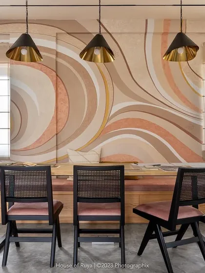Our studio's conference room balances sophistication and creativity. The custom-painted abstract wall art in earthy pastels creates a soothing atmosphere, while the black-stained Chandigarh chairs provide a sharp, contemporary contrast for focused client meetings.