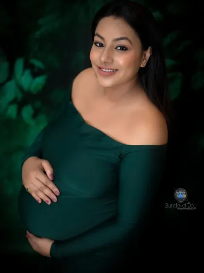 I love playing with different moods in my studio. For this portrait, we chose a deep emerald green off the shoulder dress and a dark, leafy backdrop to create a rich, artistic image that feels both intimate and dramatic.
