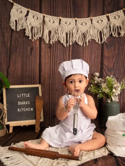 What's cooking? This little chef is curiously tasting the whisk. These unscripted moments are often the most memorable.