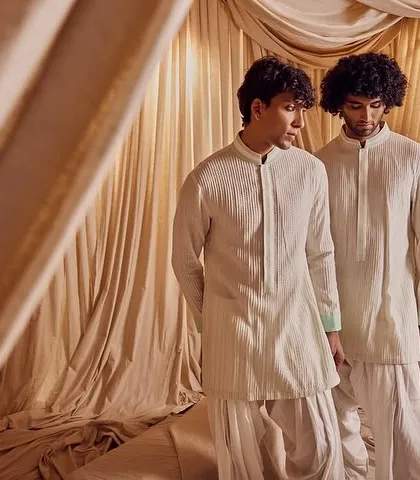 Two groomsmen in coordinated outfits. Their grooming is clean and consistent, showcasing my ability to create a unified and polished look for the entire male side of the wedding party.