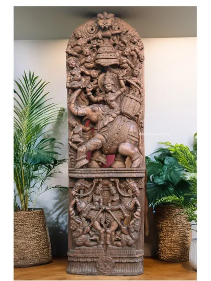 Our Raj Bhavani panel displayed in a contemporary setting with indoor plants. This shows the versatility of our traditional carvings, which can complement various interior design styles, from classic to modern.