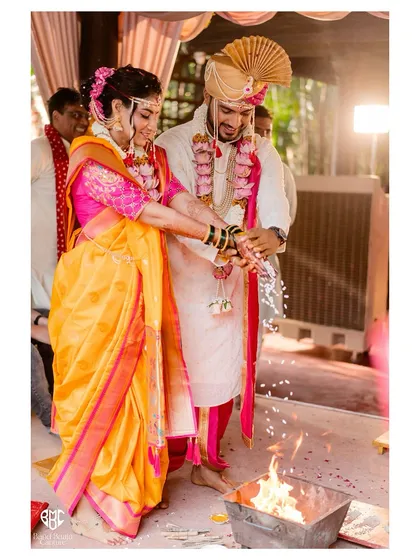 The sacred fire is central to the pheras in this Maharashtrian wedding. We capture the ritual with a focus on the couple's participation and the traditional elements.