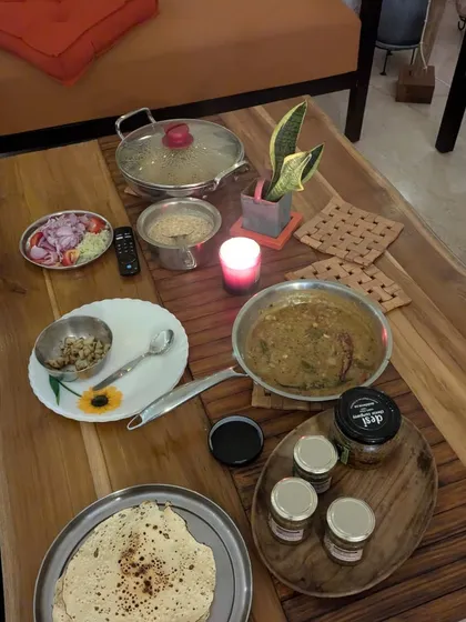 A beautiful family dinner spread on the table. We believe food is a celebration, a memory we are building together. It's about comfort, happiness, and health.