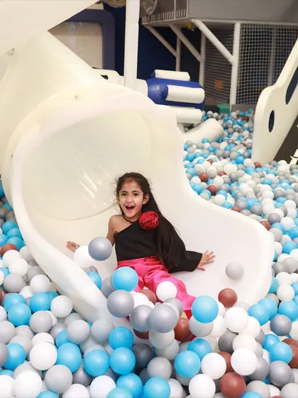 The pure joy of sliding into a sea of colorful balls! Our giant ball pit and slide is a favorite, providing endless laughter and picture perfect moments.