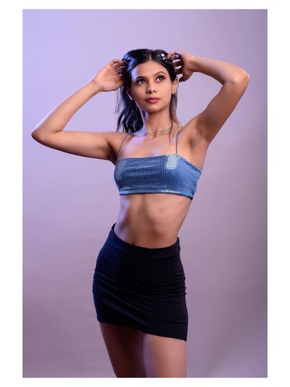 A fun and energetic studio shot with creative lighting. The pose and accessories give this portrait a modern, pop-inspired vibe.
