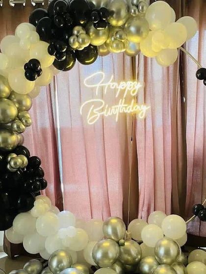 A modern and elegant birthday balloon ring in a monochrome palette of black, white, and chrome silver.