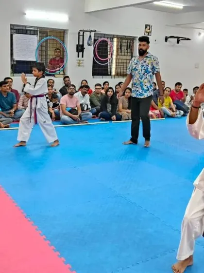 An instructor watches over students practicing their form.
