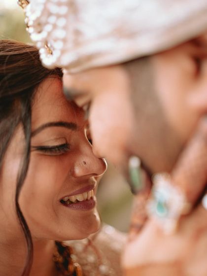 An artistic, tight close-up of the couple, focusing on their smiles and the intimacy of the moment.