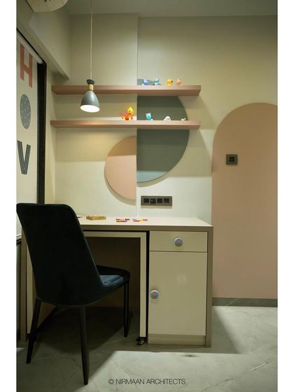 A close-up of the study desk in the toddler's room. The open shelves are perfect for displaying favorite toys, while the desk provides a dedicated spot for drawing and activities.