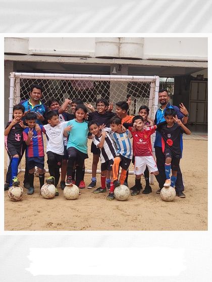 A team of our young footballers posing with their coaches by the goal. These sessions are about more than just practice; they are about building a team and fostering a shared passion for the game.