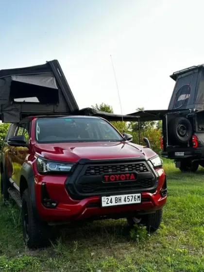 A view of the red Toyota Hilux overland truck, fully kitted out for an adventure. Our farms are accessible and welcoming to all kinds of explorers.