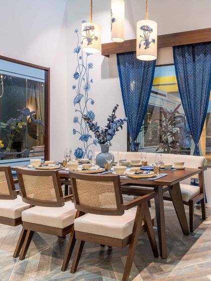 A dining space from our Design Democracy booth, where our bespoke furniture meets the rich textiles of Gaurang Home. The wood and cane chairs, paired with a simple, elegant table, create a unified theme that invites guests to linger and connect.