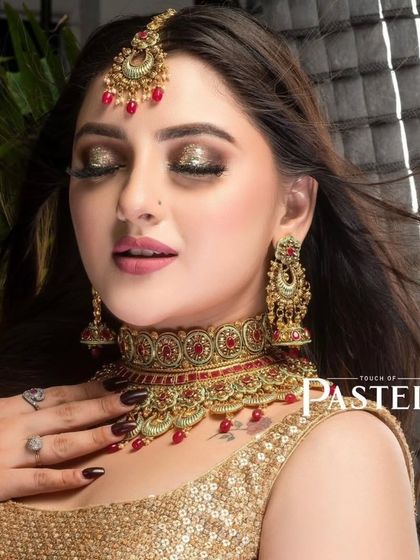 A glamorous shot of a model wearing a red and gold choker, perfect for a festive occasion or a wedding party.