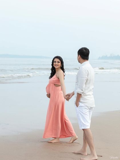A playful moment on the beach, leading him towards the water. These candid shots are full of life and personality.