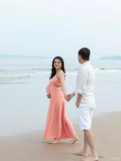 A playful moment on the beach, leading him towards the water. These candid shots are full of life and personality.