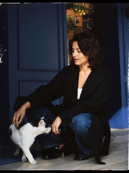 A candid moment between Priya and a friendly cat. The black and white with a film-like border gives it a timeless, storybook feel.